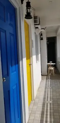 a blue and yellow door in a hallway with a table at Innsite Room Rentals in Manila