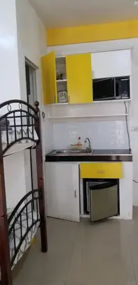 a small kitchen with a sink and a microwave at Innsite Room Rentals in Manila