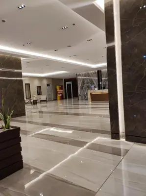 a lobby with a marble floor and a building at Schönes Apartment mit Pool-Nutzung in Manila