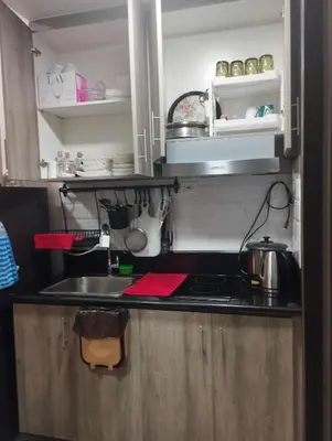 a kitchen with a sink and a counter top at Schönes Apartment mit Pool-Nutzung in Manila