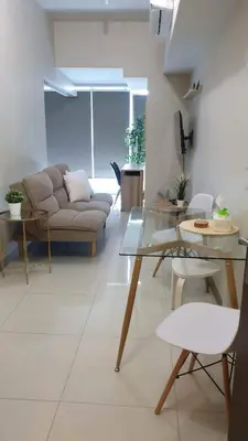 a living room with a couch and a table at 1BR executive unit in Uptown Parksuites BGC in Manila