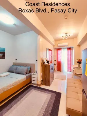 a bedroom with a bed and a couch at Coast Residences, Roxas Blvd, Pasay City in Manila