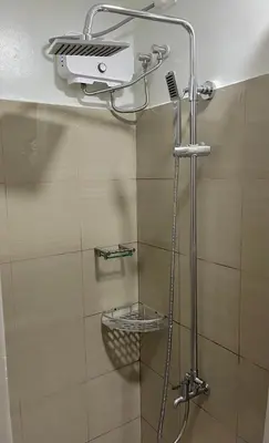 a shower in a bathroom with a glass door at Coast Residences, Roxas Blvd, Pasay City in Manila