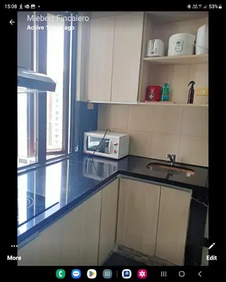 a kitchen with a sink and a microwave at MANILABAY HOME in Manila