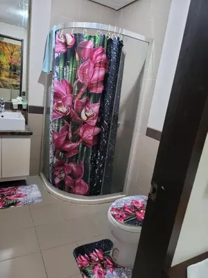 a bathroom with a toilet and a mirror at MANILABAY HOME in Manila