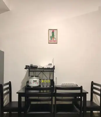 a room with two chairs and a table with food on it at Cozy Bedroom FAME Condo Greenfield EDSA MRT Shaw in Manila
