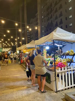 a group of people standing in front of a fruit stand at S&S CondoTel STUDIO TYPE One Palm Tree Villas in Manila