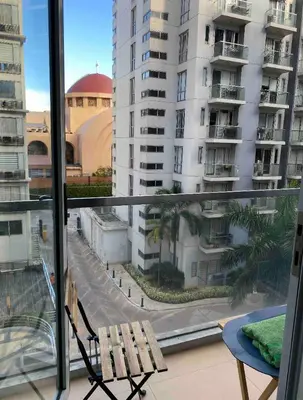 a balcony with a bench and a view of a city at S&S CondoTel STUDIO TYPE One Palm Tree Villas in Manila