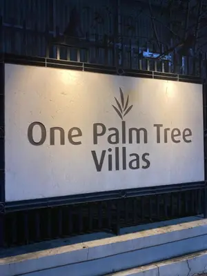 a sign that reads one palm tree villas at S&S CondoTel STUDIO TYPE One Palm Tree Villas in Manila