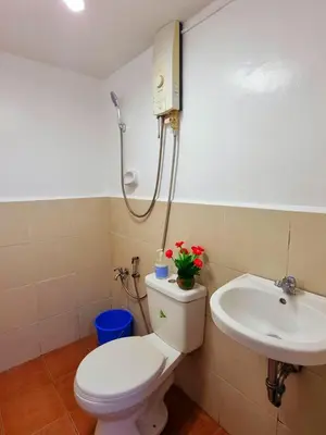 a bathroom with a toilet and a sink at Fetalino's Place Imus in Imus