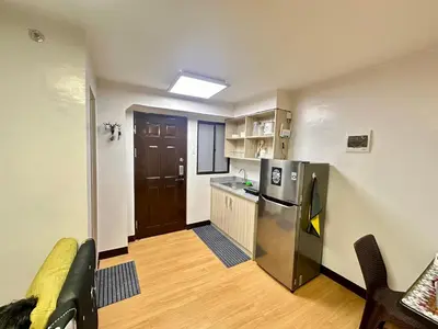 a kitchen with a stainless steel refrigerator and a counter at Fetalino's Place Imus in Imus