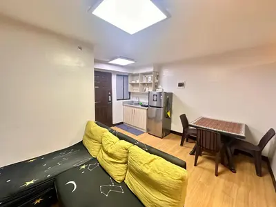 a living room with a couch and a table at Fetalino's Place Imus in Imus