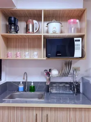 a kitchen with a sink and a microwave at Fetalino's Place Imus in Imus