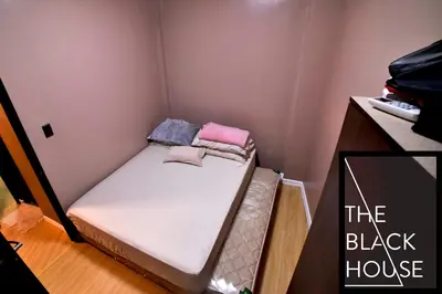 a small room with a small bed in it at The Black House in Dulong Bayan