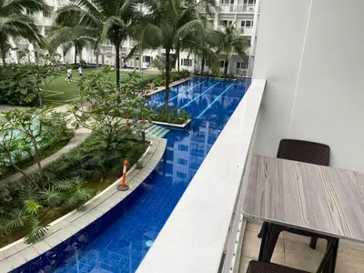a view of a pool from the balcony of a hotel at Shore Residence D3 Shortwalk mall of Asia near airport in Manila