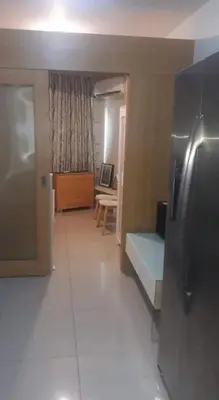 a hallway of a room with a bed and a table at SHELL RESIDENCE C1 shortwalk MALL OF ASIA NEAR AIRPORT in Manila