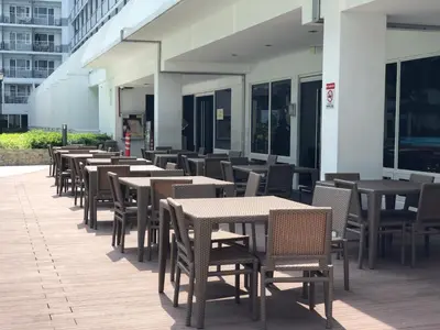 a row of tables and chairs on a patio at MOA CONDOTEL MANILA in Manila
