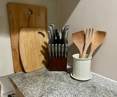 a counter with wooden utensils and a container of knives at Bright 2-bedroom condo with pool in BGC Uptown in Manila