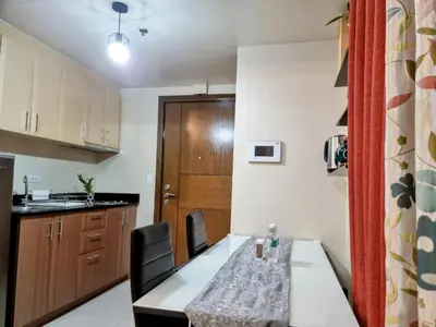a kitchen and dining room with a table and chairs at Condo Airport NAIA Terminal-3 One Palm Tree Villas in Manila