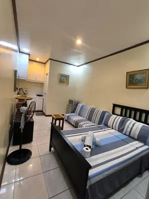 a living room with a bed and a couch at South Breeze Balibago 3 minutes away from Santa Rosa Commercial Complex in Macabling