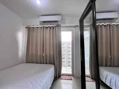 a bedroom with two beds and a large window at Studio Units at Shore Residences Condo MOA Complex near Airport in Manila