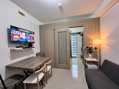 a living room with a wooden table and a couch at Studio Units at Shore Residences Condo MOA Complex near Airport in Manila