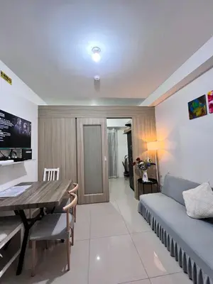 a living room with a table and a couch at Studio Units at Shore Residences Condo MOA Complex near Airport in Manila