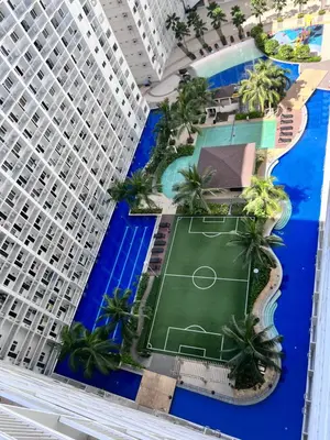 an overhead view of a tennis court in front of a building at Studio Units at Shore Residences Condo MOA Complex near Airport in Manila