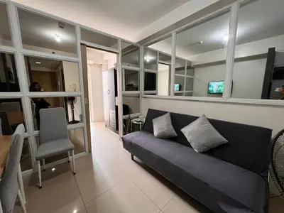 a living room with a couch and a chair at Studio Units at Shore Residences Condo MOA Complex near Airport in Manila