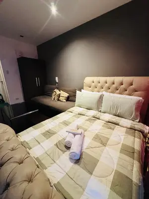 a large bed with two towels on top of it at Gramercy Residences studio with Balcony Netflix in Manila
