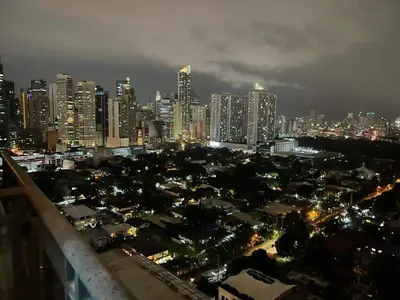 a view of a city at night with buildings at Gramercy Residences studio with Balcony Netflix in Manila