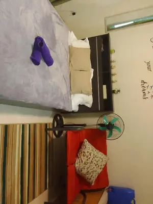 a bunk bed with a mirror and a pile of towels at Studio for Rent near Ortigas Extension in Cainta