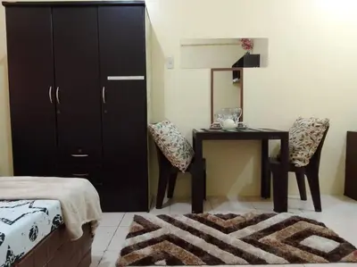 a bedroom with a desk and a table with chairs at For Rent in Cainta, Rizal: Short / Long Term Lease in Cainta
