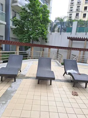 three chairs sitting on a patio in a building at MRMcondotel in Manila