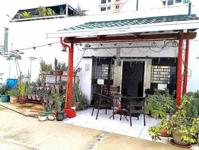 a patio with a table and chairs and plants at Rooftop Condo Makati in Manila