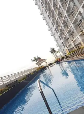a large swimming pool in a large building at Jk Coastal Inn in Manila