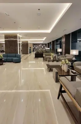 a lobby with couches and tables in a building at Jk Coastal Inn in Manila