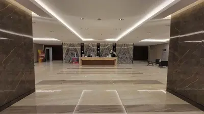 a large lobby with a desk in the middle of a building at Jk Coastal Inn in Manila