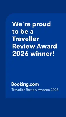 a blue sign that says were proud to be a traveller reviewagency winner at SCANDIA SUITES AT SOUTH FORBES Homey & Cozy 2-Bedroom Condo in Silang