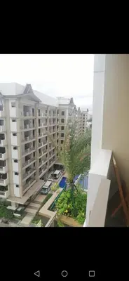 a view of a large apartment building from a window at Joey's Place Calathea DMCI in Manila