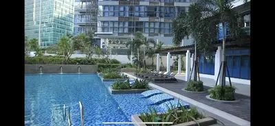 a swimming pool in the middle of a building at 1 BR condo Uptown Parksuites BGC, high floor, morning sun in Manila