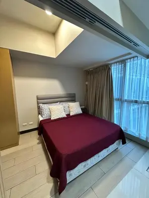 a bedroom with a bed with a large window at 1 BR condo Uptown Parksuites BGC, high floor, morning sun in Manila