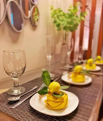 a table with two plates of food and wine glasses at SMDC Air Residence-LucasCove Sorrento Vibes in Makati in Manila