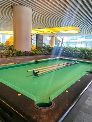 a pool table with cue sticks on top of it at SMDC Air Residence-LucasCove Sorrento Vibes in Makati in Manila