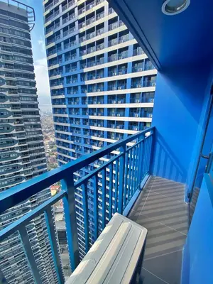 a balcony with a bench on a blue railing at SMDC Air Residence-LucasCove Sorrento Vibes in Makati in Manila