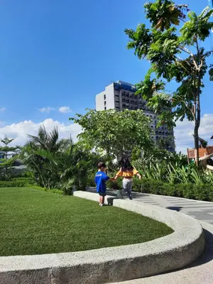 two children are holding hands in a park at SMDC Air Residence-LucasCove Sorrento Vibes in Makati in Manila