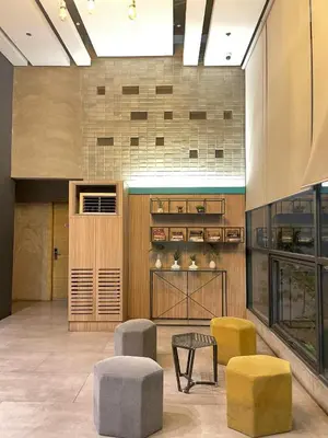 a lobby with a table and two stools and chairs at 1 bedroom Service Aprtmnt 2pax allows other 4pax 25011 in Cubao Quezon City in Manila