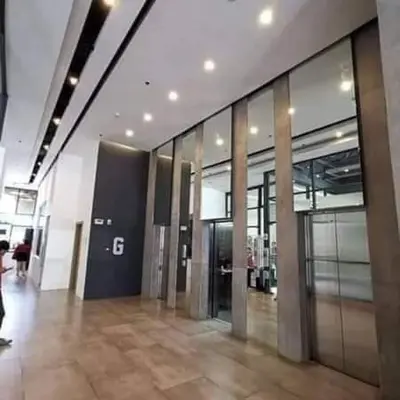 a large building with a lobby with glass doors at 1 bedroom Service Aprtmnt 2pax allows other 4pax 25011 in Cubao Quezon City in Manila