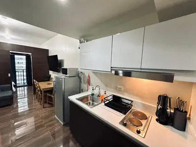 a kitchen with a sink and a stove top oven at Heart of Makati, Fully furnished condo, cbd central location in Manila