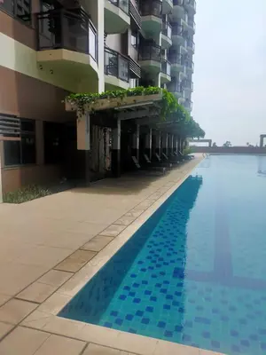 a swimming pool in front of a building at The Radiance Manila Bay in Manila